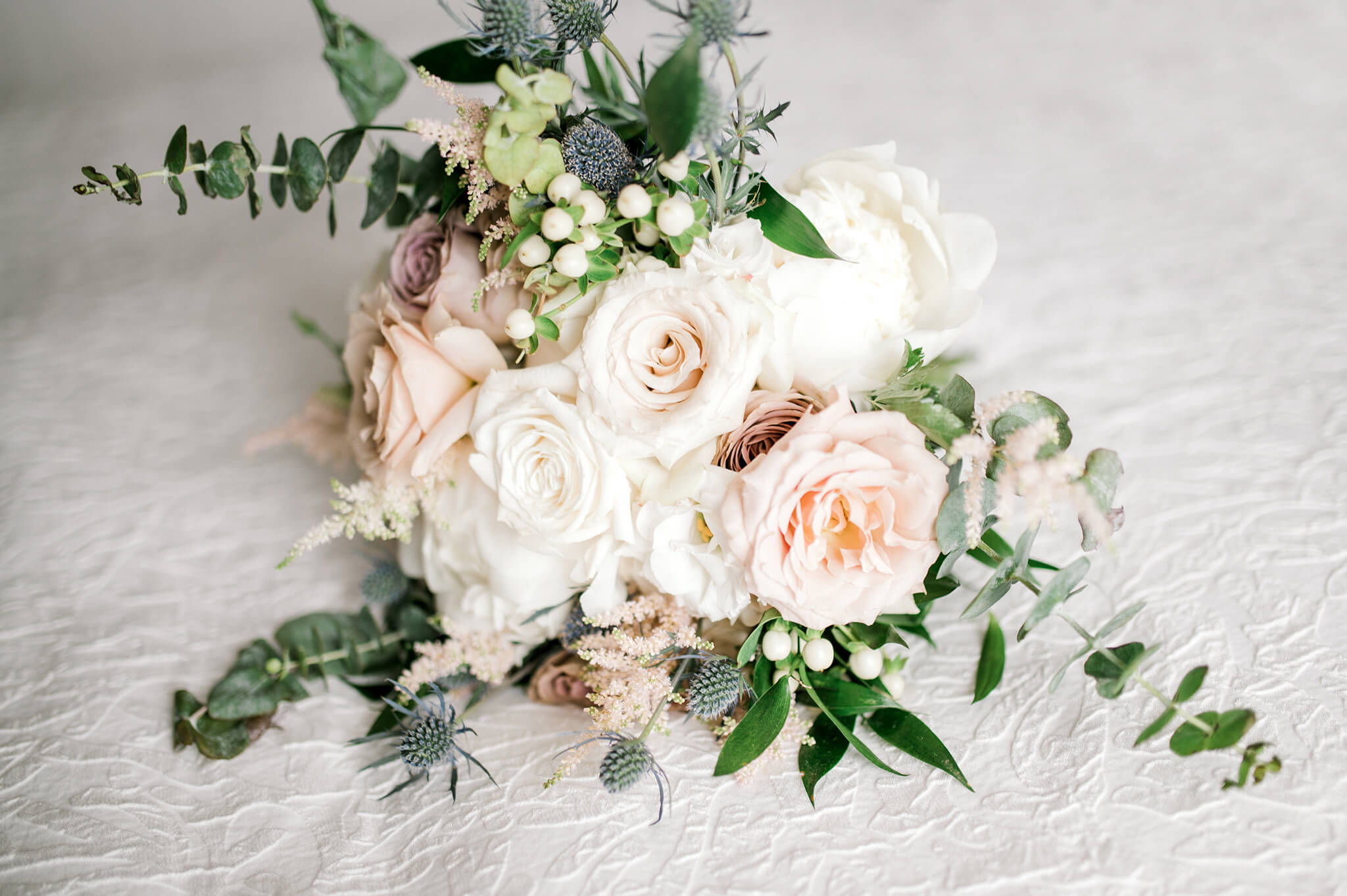 Floral Arrangement laid on the white backdrop at a Delphi Banquet Facilities Wedding